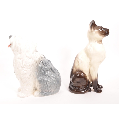 96 - Beswick - Two vintage 20th century porcelain ceramic animal figures / statues. Comprising of a Siame... 