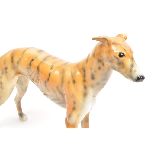 90 - Beswick / Royal Doulton style - A 20th Century vintage ceramic greyhound / whippet figure in the sty... 