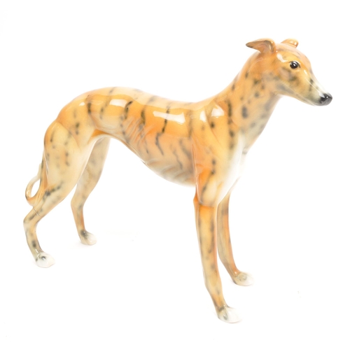 90 - Beswick / Royal Doulton style - A 20th Century vintage ceramic greyhound / whippet figure in the sty... 