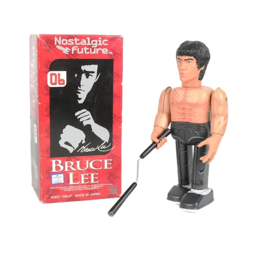 446 - Tinplate Toys - a Japanese Medicom Bruce Lee robot, featuring walking action and swinging arms, with... 