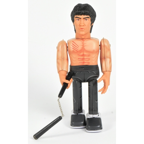 446 - Tinplate Toys - a Japanese Medicom Bruce Lee robot, featuring walking action and swinging arms, with... 