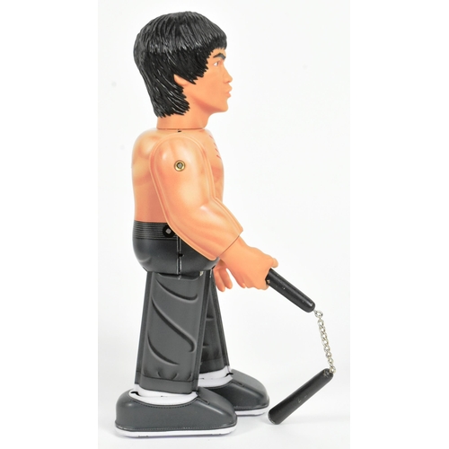 446 - Tinplate Toys - a Japanese Medicom Bruce Lee robot, featuring walking action and swinging arms, with... 