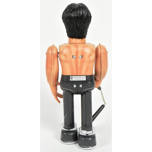 446 - Tinplate Toys - a Japanese Medicom Bruce Lee robot, featuring walking action and swinging arms, with... 