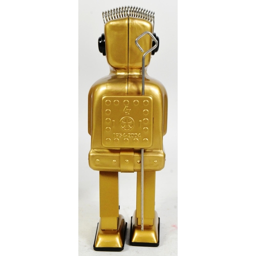 488 - Tinplate Toys - a 2004 Strauss Toys Strenco wind-up robot, in gold. Featuring walking action, and sp... 