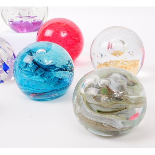 103 - A collection of eleven vintage 20th century bubble control glass paperweights. The lot to include fa... 