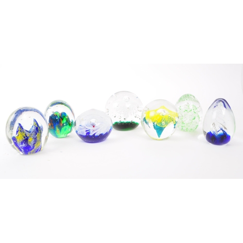 115 - A collection of x7 vintage 20th century glass paperweights. To include bubble control, floral and sw... 