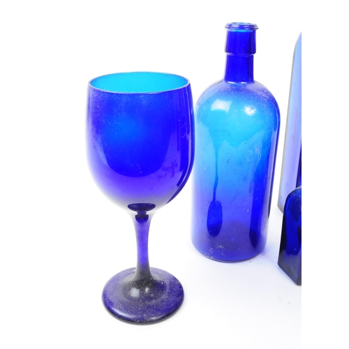 116 - A collection of 20th century Bristol Blue glass. To include bobbin turn glass bud vase / decanter, d... 