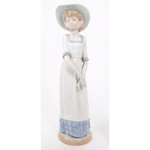 23 - Nao / Lladro—A collection of vintage 20th-century Spanish porcelain figures/statues. All depict fema... 