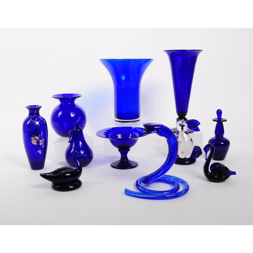 34 - A collection of 20th century Bristol blue glass decorative pieces. The collection containing example... 