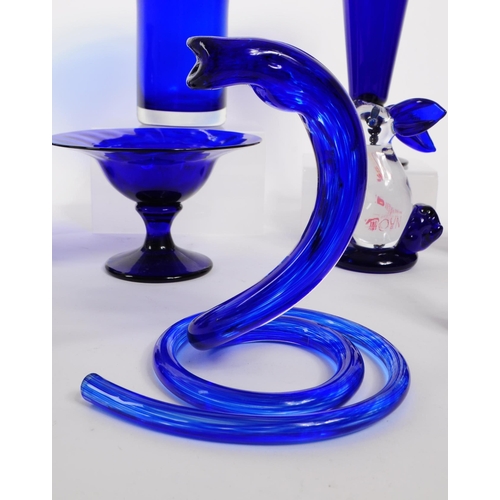 34 - A collection of 20th century Bristol blue glass decorative pieces. The collection containing example... 