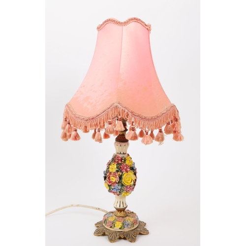 61 - An early 20th century Italian porcelain table lamp light. Having a gilt foliate base, with hand pain... 