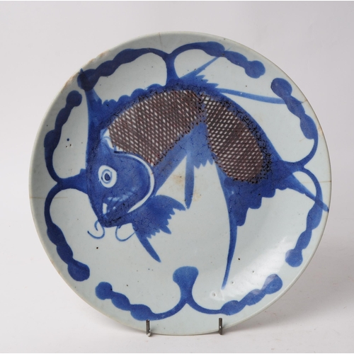 74 - A 19th century Chinese blue and white fish algae display plate. Depicting a leaping carp on a cerami... 