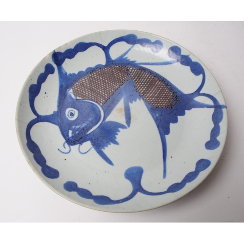 74 - A 19th century Chinese blue and white fish algae display plate. Depicting a leaping carp on a cerami... 