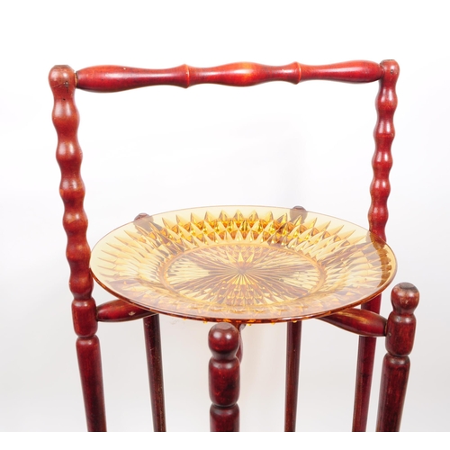 78 - Early 20th amber glass Chinese hard wood plate / tea cake rack. Having a turned carry handle with tu... 