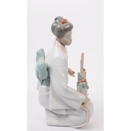 90 - LLadro, Spain - A large hand painted fine bone china porcelain figure of kneeling geisha. The figure... 