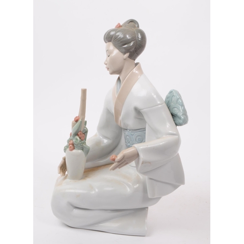 90 - LLadro, Spain - A large hand painted fine bone china porcelain figure of kneeling geisha. The figure... 