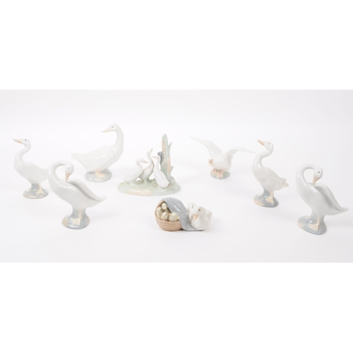 91 - LLadro & Nao by Lladro - A collection of eight hand painted fine bone china porcelain figures of... 