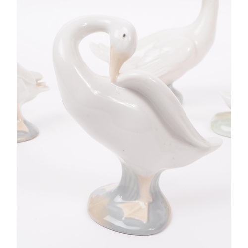 91 - LLadro & Nao by Lladro - A collection of eight hand painted fine bone china porcelain figures of... 