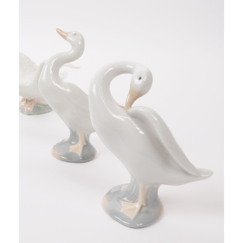 91 - LLadro & Nao by Lladro - A collection of eight hand painted fine bone china porcelain figures of... 