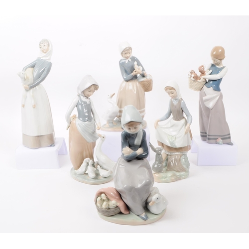 94 - LLadro, Spain - a collection of six hand painted fine bone china porcelain figures of ladies with fa... 