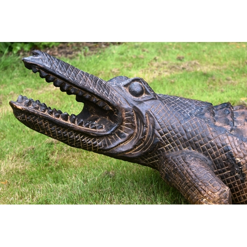 11 - Former Bristol Zoo Gardens - a large carved hardwood crocodile sculpture. Carved with mouth open and... 