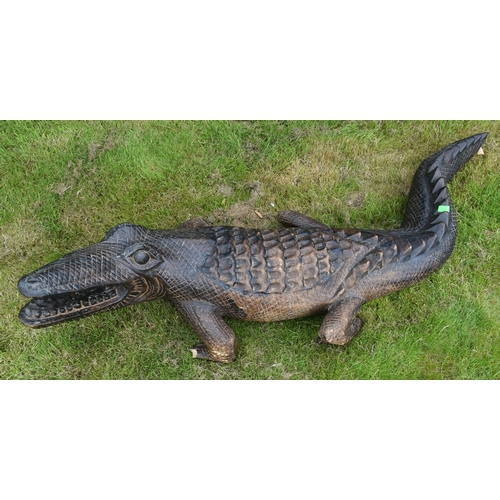 11 - Former Bristol Zoo Gardens - a large carved hardwood crocodile sculpture. Carved with mouth open and... 