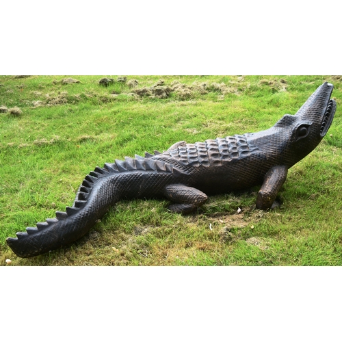 11 - Former Bristol Zoo Gardens - a large carved hardwood crocodile sculpture. Carved with mouth open and... 