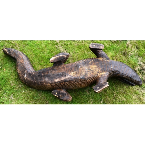 11 - Former Bristol Zoo Gardens - a large carved hardwood crocodile sculpture. Carved with mouth open and... 