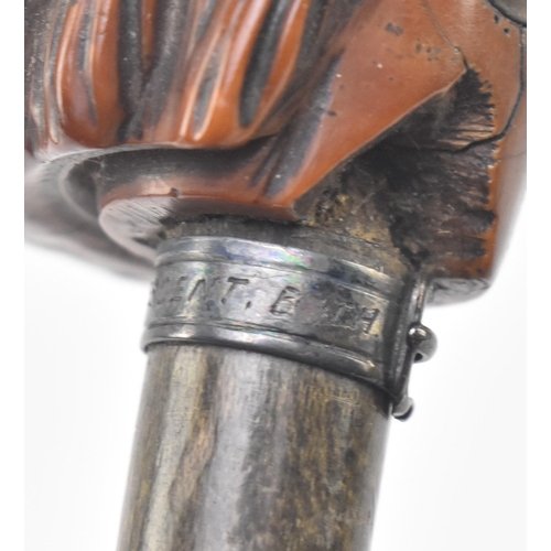 109 - An early 20th century wooden walking stick pommel carved as the head of a dog. The pommel having a c... 