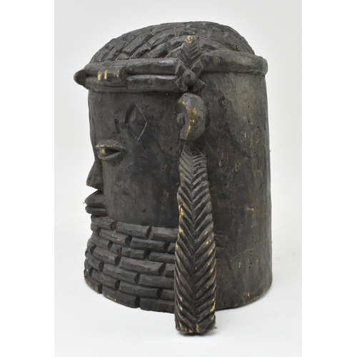 112 - An African Nigerian Benin carved wood head of an Oba (King). The King wearing coral bead necklace ra... 