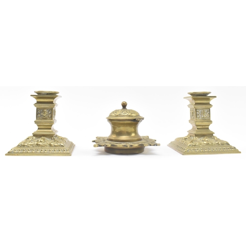 121 - A pair of late 19th century Victorian square brass candlesticks, together with a similar lidded inkw... 