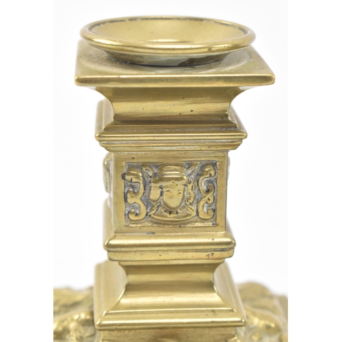 121 - A pair of late 19th century Victorian square brass candlesticks, together with a similar lidded inkw... 