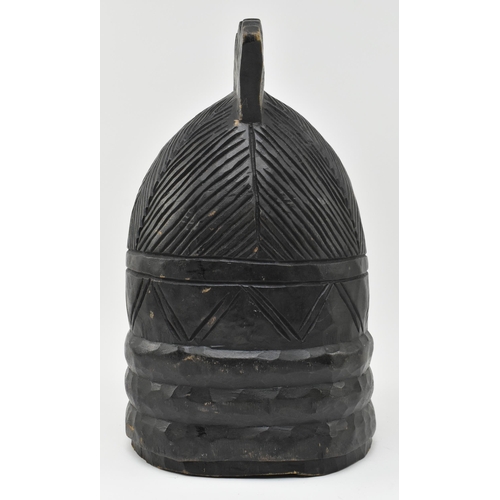 122 - A tribal Mende helmet mask (Ndoli Jowei) for Sande Society, the carved wooden helmet mask in form of... 