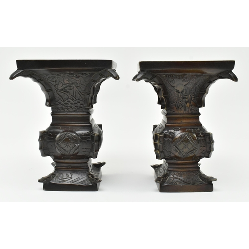 125 - A pair of Japanese 19th century bronze Gu form archaic flower vases. Each having a squared mouth ove... 