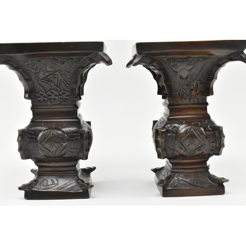 125 - A pair of Japanese 19th century bronze Gu form archaic flower vases. Each having a squared mouth ove... 