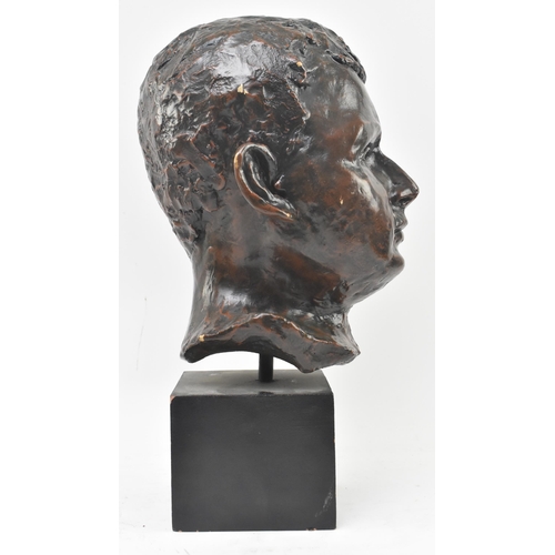 133 - A 20th century bronzed resin sculpture of child's head on plinth base. The subject depicted frontall... 