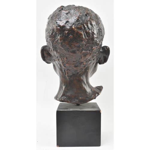 133 - A 20th century bronzed resin sculpture of child's head on plinth base. The subject depicted frontall... 