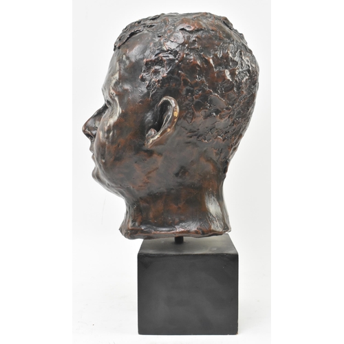 133 - A 20th century bronzed resin sculpture of child's head on plinth base. The subject depicted frontall... 