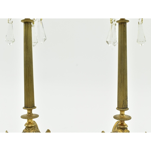 161 - A pair of French Empire 19th century brass & glass candlesticks. Each candlestick having a shape... 