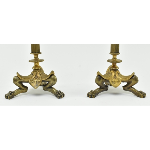 161 - A pair of French Empire 19th century brass & glass candlesticks. Each candlestick having a shape... 