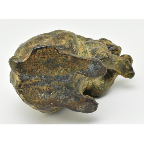 166 - A 20th century cast bronze figurine of a hare. The figure with textured design, modelled with paws &... 