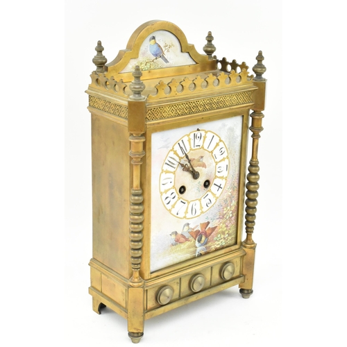 170 - A late 19th century French mantle clock with porcelain face. The clock featuring pediment with brass... 