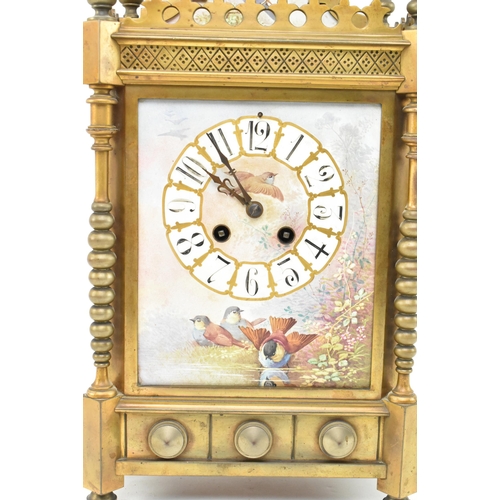 170 - A late 19th century French mantle clock with porcelain face. The clock featuring pediment with brass... 