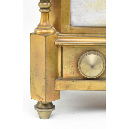 170 - A late 19th century French mantle clock with porcelain face. The clock featuring pediment with brass... 