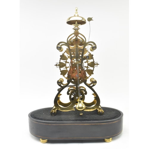 31 - An early 20th century brass single fusee movement skeleton mantel clock in glass dome. The clock hav... 