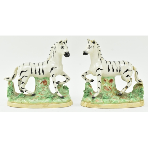 54 - A collection of eight Victorian 19th century Staffordshire hand painted porcelain figures of zebras.... 