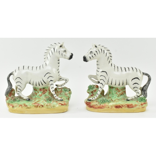 54 - A collection of eight Victorian 19th century Staffordshire hand painted porcelain figures of zebras.... 