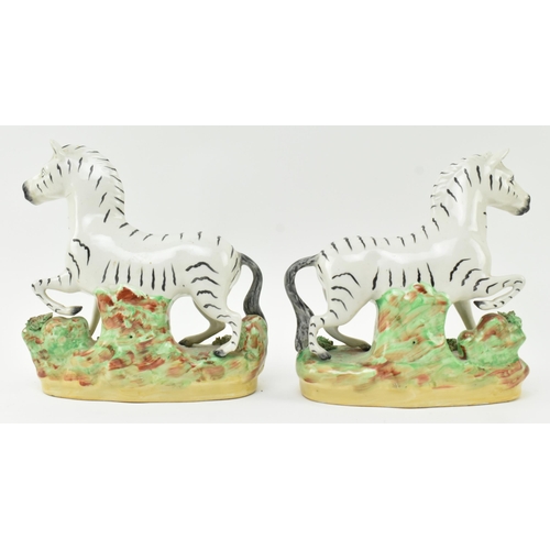 54 - A collection of eight Victorian 19th century Staffordshire hand painted porcelain figures of zebras.... 