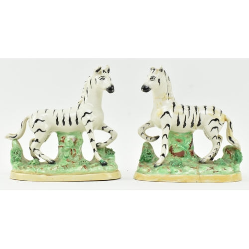 54 - A collection of eight Victorian 19th century Staffordshire hand painted porcelain figures of zebras.... 