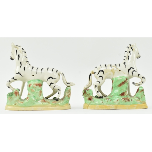 54 - A collection of eight Victorian 19th century Staffordshire hand painted porcelain figures of zebras.... 